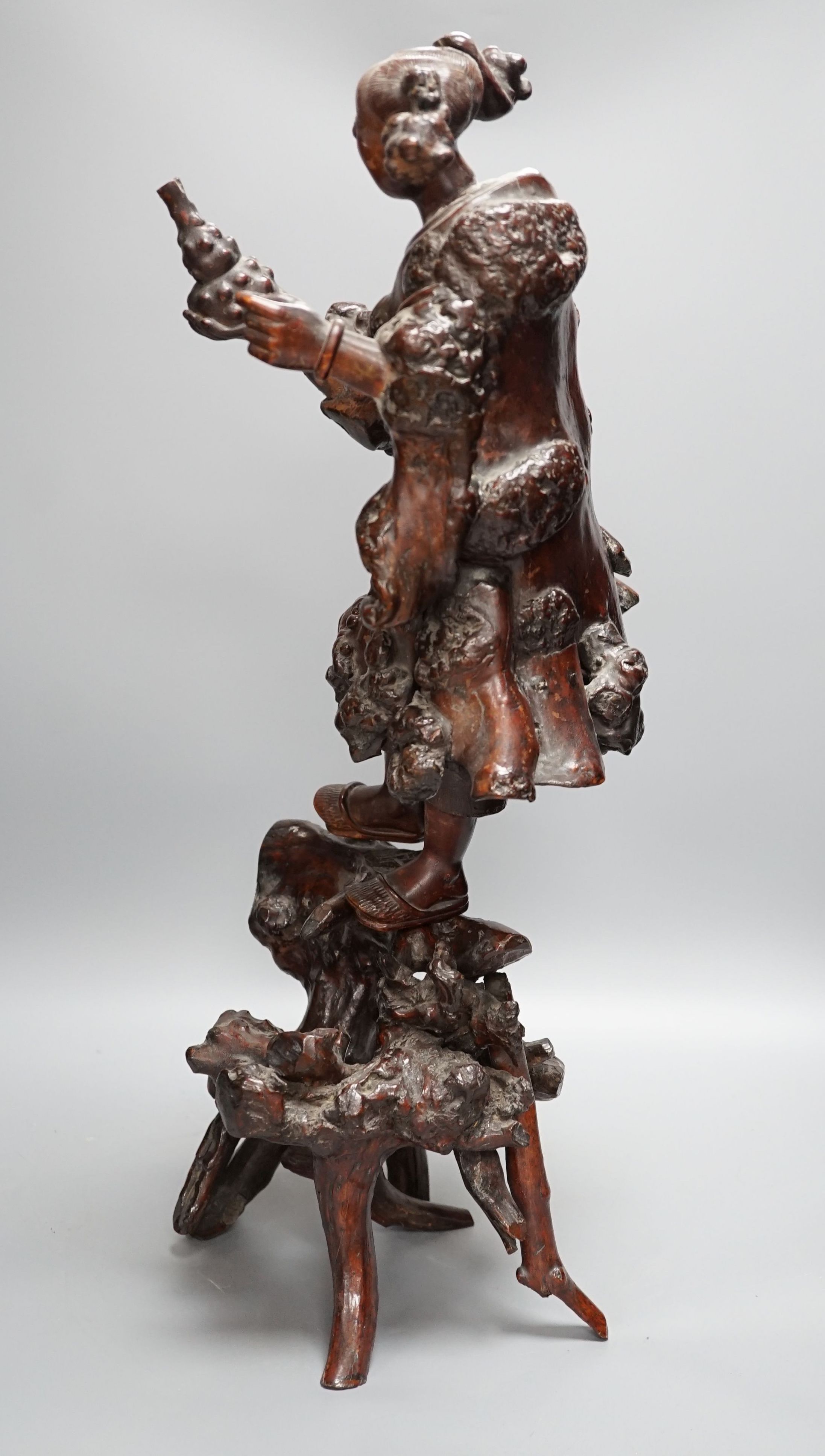 A Chinese root carving of a lady, 57cm